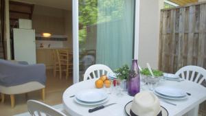 a white table with white plates on top of it at VVF Lac d'Eguzon in Éguzon-Chantôme +9 photos