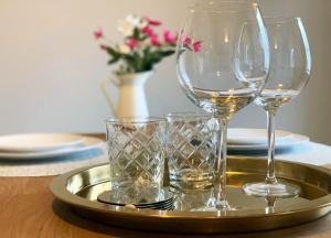 a tray with wine glasses on a table at Portstewart Coastal 3 Bedroom House with Free Parking in Portstewart
