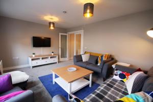 a living room with a couch and a table at Strand House 2 in Portstewart