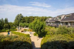 an aerial view of a house with a playground at Residence Terschelling Wellness Waddenresort in Midsland
