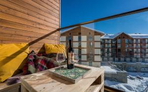 una mesa con una copa de vino en el balcón en New Gudauri, Red Co, Loft 1, Apartment 521, en Gudauri