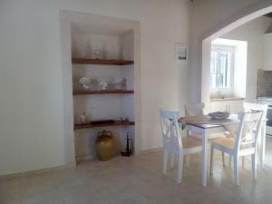 a dining room with a table and chairs at Atrium House - Boletsis in Anapaftíria