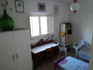 a kitchen with a desk and a refrigerator and a window at Casa del Monte in Antonelli