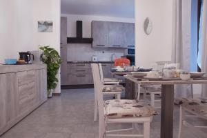 a kitchen with a table and chairs in it at La Poesia del Lago in Oggiono
