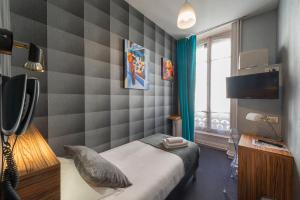 Voodi või voodid majutusasutuse Hotel de Paris toas