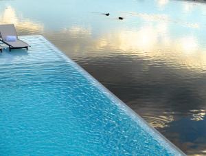 a body of water with a body of water with a blue sky at Casa de Uco Vineyards and Wine Resort in Los Árboles
