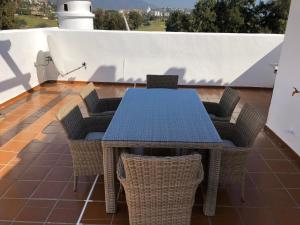 a blue table and chairs on a roof at La Siesta de Mijas Golf 174 in Fuengirola