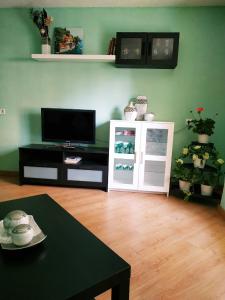 a living room with a tv and a table at Apartment in Valencia in Valencia