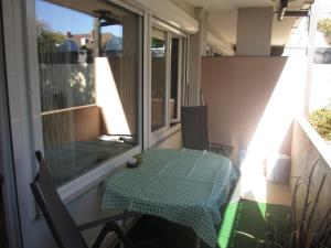 a table and chairs on a balcony with a table and a window at Im Zentrum Hebelhof 2 Zi. in Freiburg im Breisgau