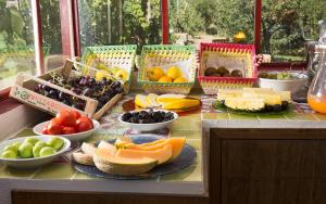 a table filled with different types of fruits and vegetables at Capri Wine Hotel in Capri