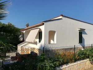 a white house with a fence in front of it at Villini Giovanna Disanti in Vieste