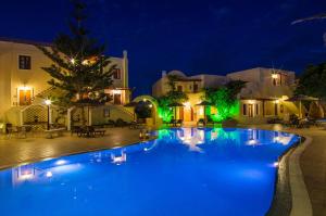 a large swimming pool at night with lights at Smaragdi in Perivolos