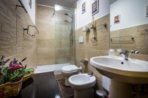 a bathroom with a sink and a toilet and a shower at B&B De Biffi in Florence