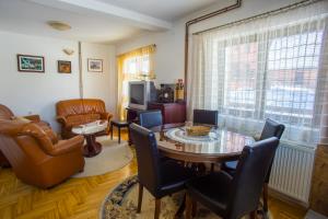a living room with a table and chairs at Apartmani Mila in Žabljak