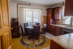 a kitchen with a table and chairs in a kitchen at Apartmani Mila in Žabljak