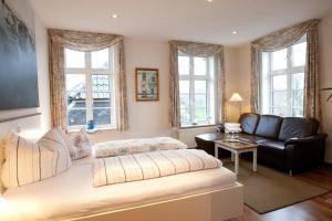 a living room with a bed and a couch at Hotel Restaurant Friedrichs in Nebel