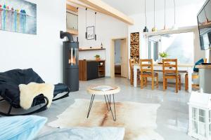 a living room with a stove and a table at Beerenhaus in Kurort Altenberg