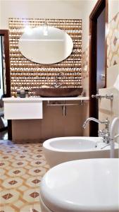 a bathroom with a tub and a toilet and a sink at Casa Franco in Marina di Campo