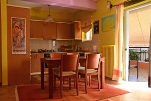 a kitchen with a table and chairs in it at Theo and Kaiti in Athens