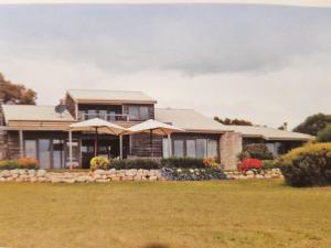 a house with a large yard in front of it at tu Emuz Stone Beachfront Villa, Emu Bay, Kangaroo Is in Emu Bay