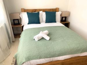 a bed with a rolled up towel on it at Home Crowd Luxury Apartments- Hamilton House in Doncaster