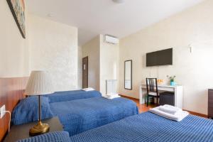 Posteľ alebo postele v izbe v ubytovaní Roma Enrico Guesthouse