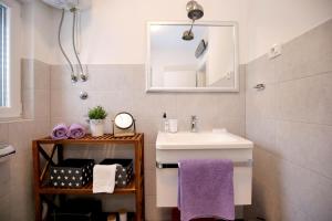 a bathroom with a sink and a mirror at NeRea Apartment Molat in Molat +108 photos