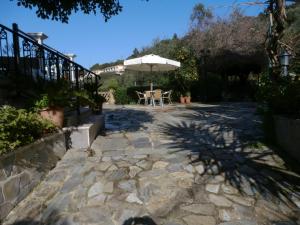 a patio with an umbrella and a table and chairs at Anna Studio and Apartments in Tsilivi +180 photos