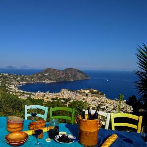 a table with a view of a city and the ocean at al numero zero in Lipari