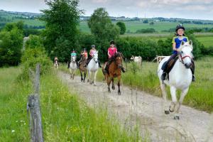 a group of people riding horses down a dirt road at Nengshof Ferienwohnungen Mohnblume und Kornblume in Wißmannsdorf