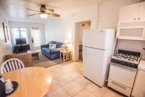 a kitchen and living room with a refrigerator and a table at Pismo Beach Hotel in Pismo Beach