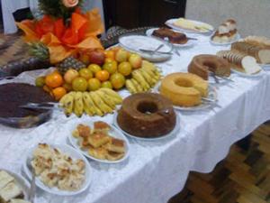 a table topped with plates of different types of food at Hotel Maristela in São Joaquim