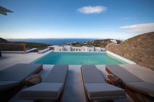 a swimming pool with a view of a villa at VILLA APHRODITE- PRIVATE POOL- AMAZING AEGEAN VIEW in M&yacute;konos City