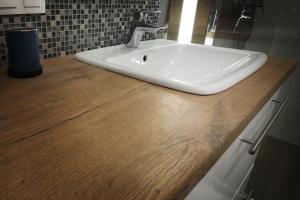 a white sink on a wooden counter in a bathroom at Sea Haven - Morska Przystań in Jelitkowo +15 photos
