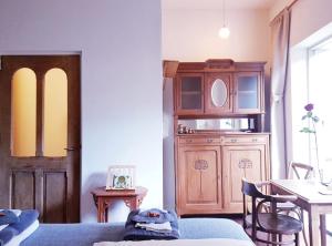 a living room with a wooden cabinet and a table at SintAnna B&B PetitHotel in Yerseke