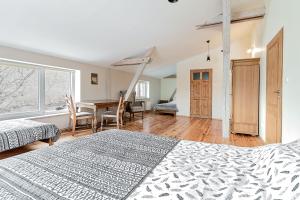 a bedroom with a bed and a desk and a table at Villa Oranje in Bolków