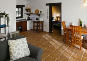 a living room with a couch and a table at Finca Felix Appartement met Private Pool! in Lajares