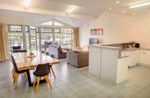 a kitchen and living room with a table and chairs at Port Lincoln Foreshore Apartments in Port Lincoln