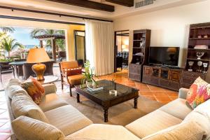 a living room with a couch and a coffee table at Hacienda Beach Club & Residences in Cabo San Lucas