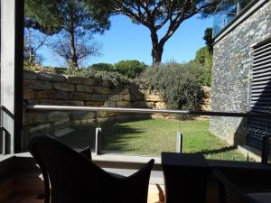 a view of a garden from a window of a house at Apartamento com 3 quartos e piscina in Vale do Lobo