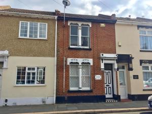 a brick house on a street at Little Connaught House in Portsmouth