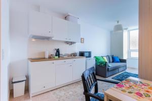 a kitchen and living room with a couch and a table at Casa Bonecos Rebeldes in Lisbon