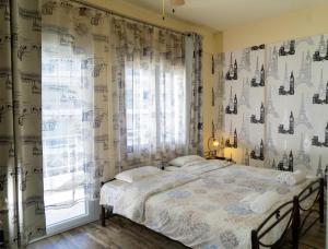 a bedroom with a bed and a window at Nomads Meteora in Tríkala