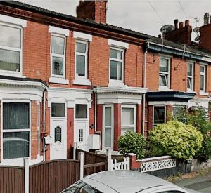 a car parked in front of a row of houses at Walthall Place by SG Property Group in Crewe