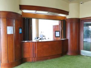 a lobby with a reception desk in a building at Putaruru Hotel in Putaruru