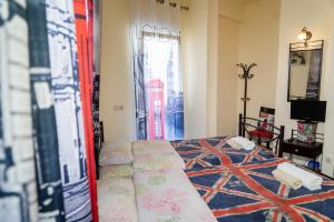 a bedroom with a bed and a window with the city at Nomads Rooms in Tríkala
