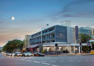 a street with cars parked in front of a building at The Metropolitan Spring Hill in Brisbane