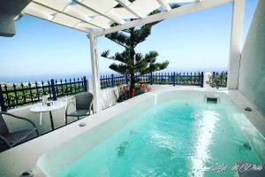 a swimming pool with a view of the ocean at Villa Happening in Imerovigli