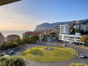 a view of a city with a park in the middle of a street at Cozy T2 with Ocean View in Funchal