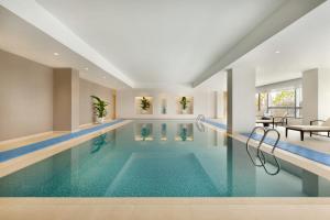 a large swimming pool in a hotel room with a swimming pool at Hyatt Place Beijing Daxing in Daxing